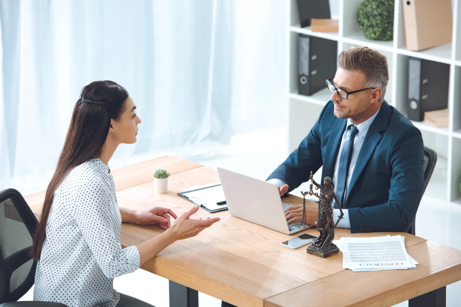 Legal professional reviewing documents with a client